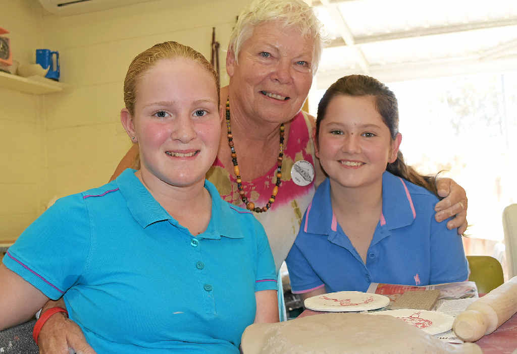THROWING DOWN A CHALLENGE: Warwick Potters president with Jewel Schnitzerling and Kaitlyn Duggan at the kids’ workshops.